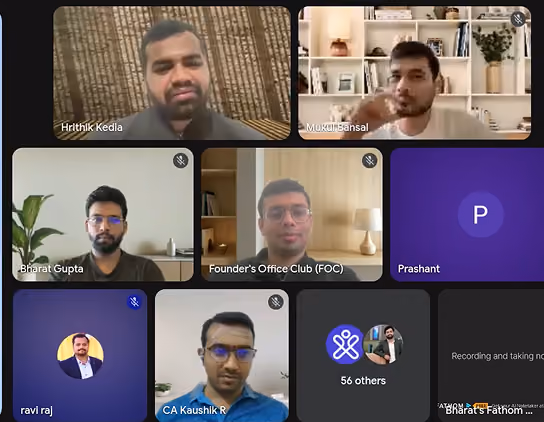 Grid of video call participants with some muted, showing faces, names, and icons on screen.